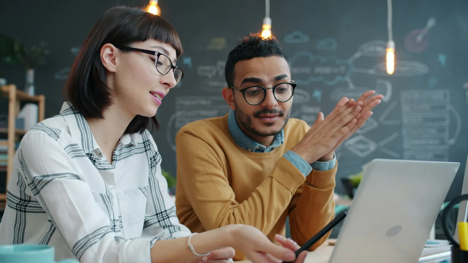 Illustrative photograph of two colleagues discussing their work